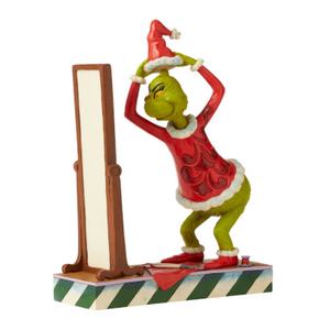 Grinch Dressing in Santa Suit in Mirror